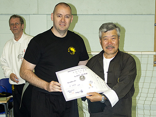 Niall Whyte receiving his 4th Degree Black Sash from Master Yau