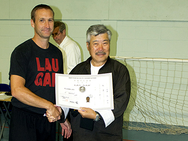 Sifu Derek Dawson receiving his 5th Degree Black Sash from Master Yau