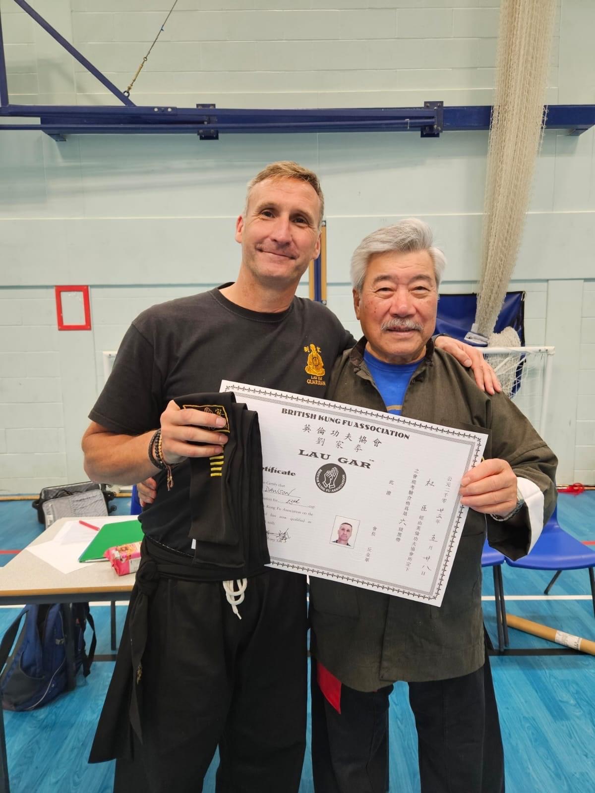 Our Sifu and Guardian Derek Dawson receiving his 6th Degree Black Sash and Certificate from Grand Master Yau.