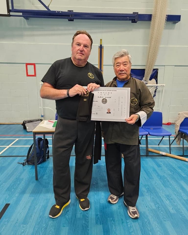 Sean Collard receiving his 2nd Degree Black Sash and Certificate from Grand Master Yau.
