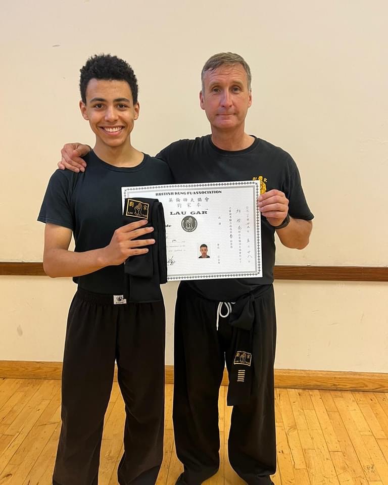 Claude O'Reilly receiving his Black Sash and Certificate from Sifu Derek Dawson.